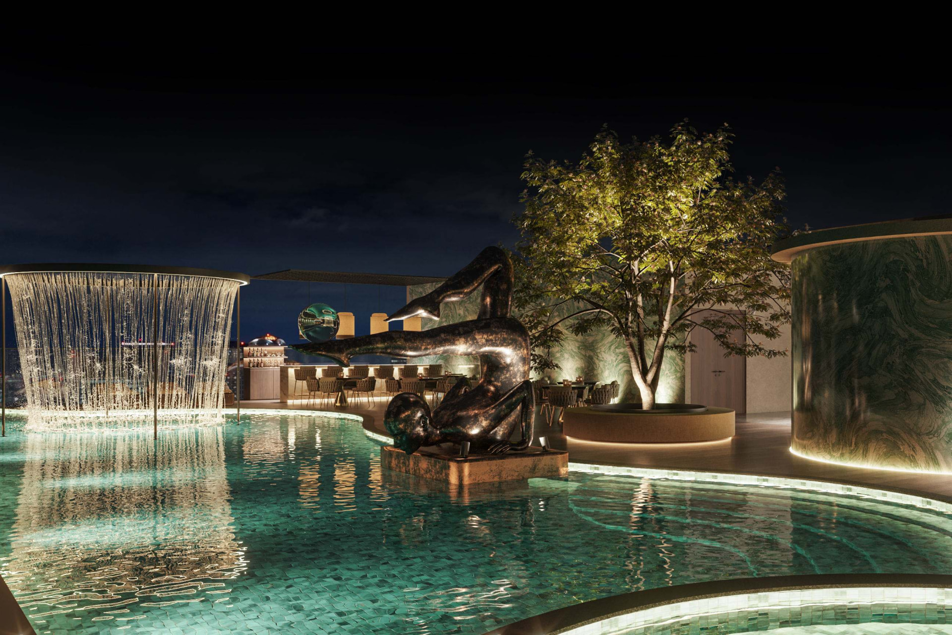 Rooftop pool deck with sculpture and rain curtain at night